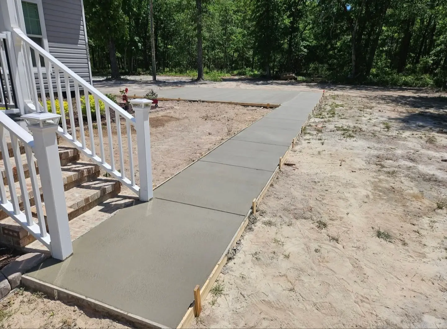 New concrete steps and walkway beside a home exterior