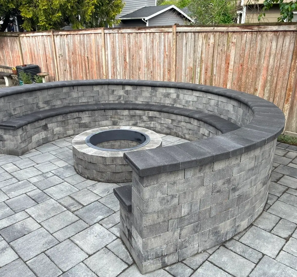 Paver patio with fire pit and curved seat wall