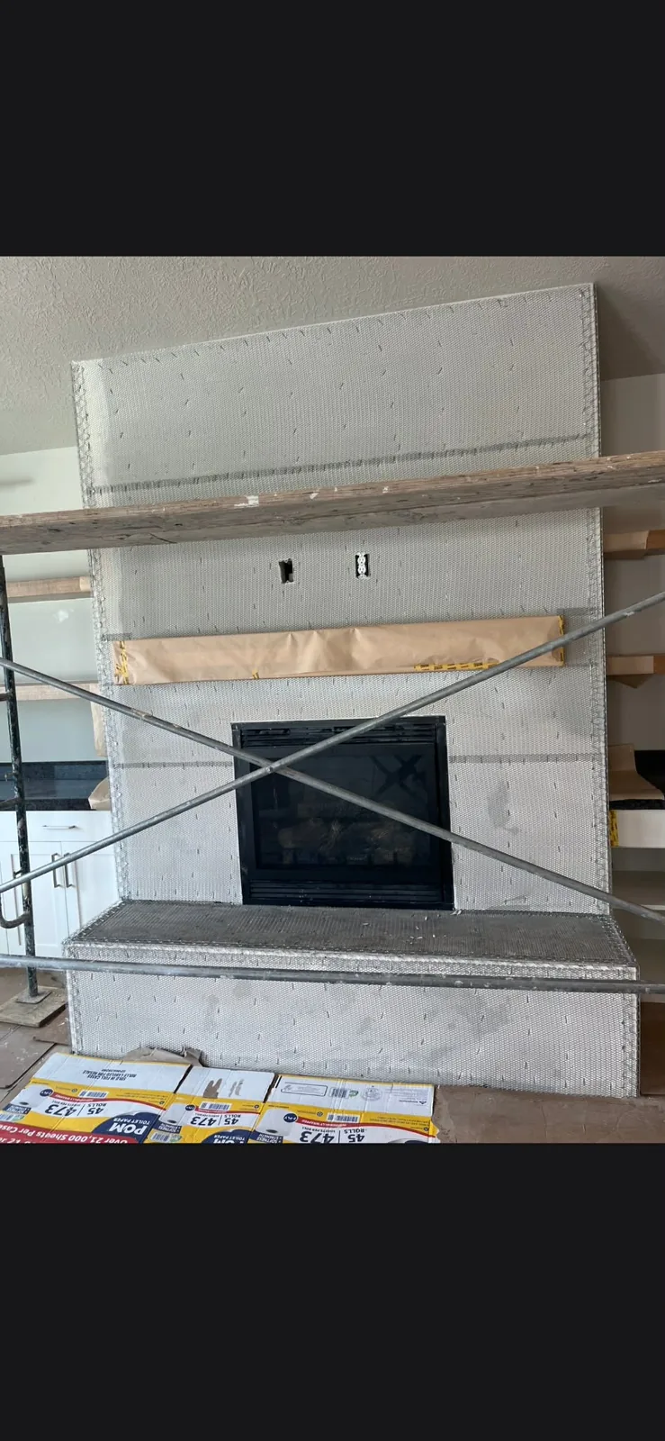 Fireplace with fiberglass mesh reinforcement for an EIFS or synthetic stucco finish