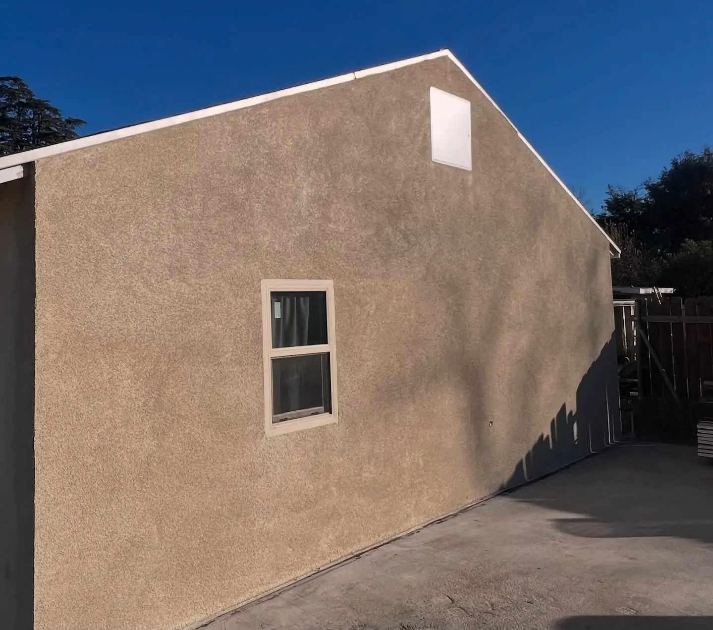 Finished hardcoat stucco exterior refresh on a residential wall