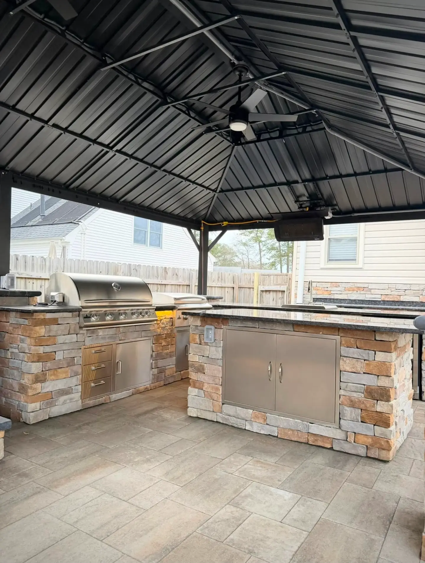 Covered outdoor kitchen and pavilion with finished concrete