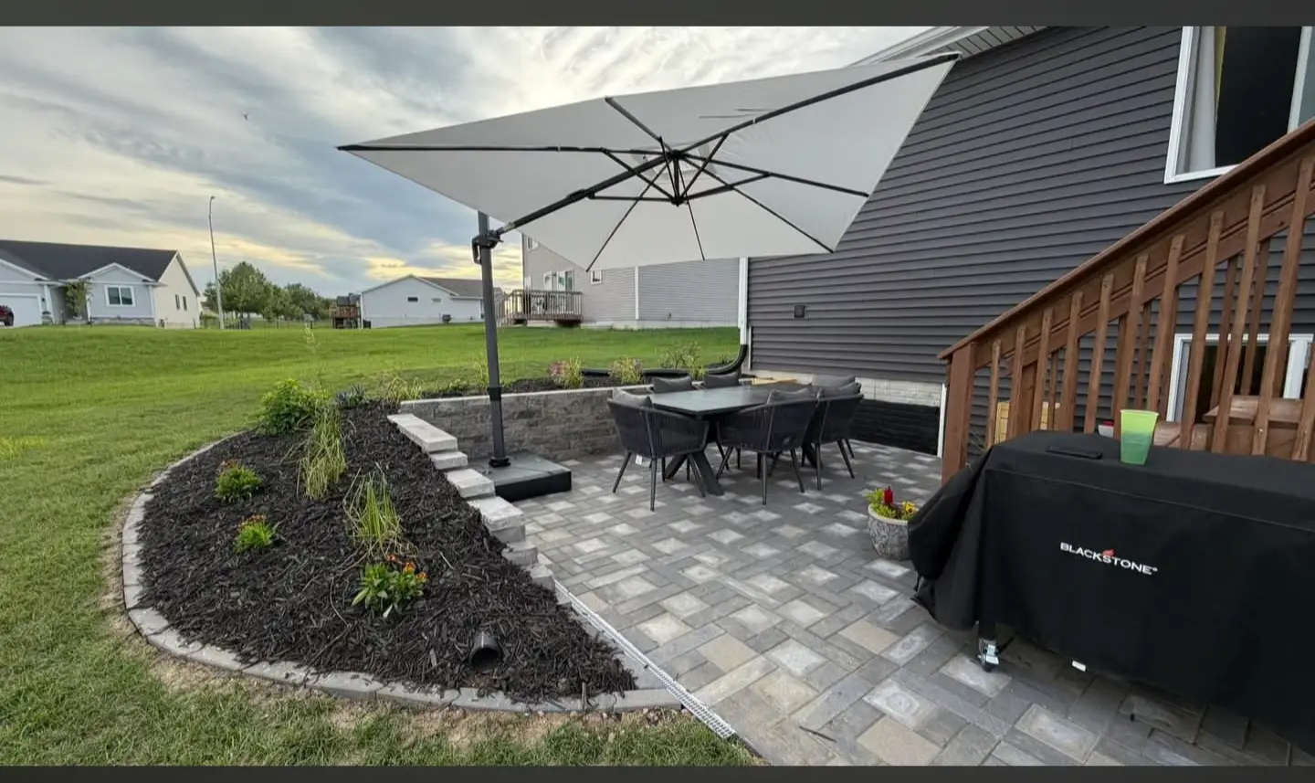 Backyard paver patio with planting beds and outdoor seating