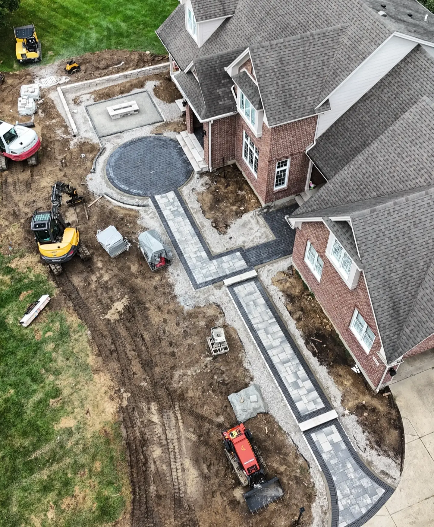 Paver walkway and courtyard installed beside a home