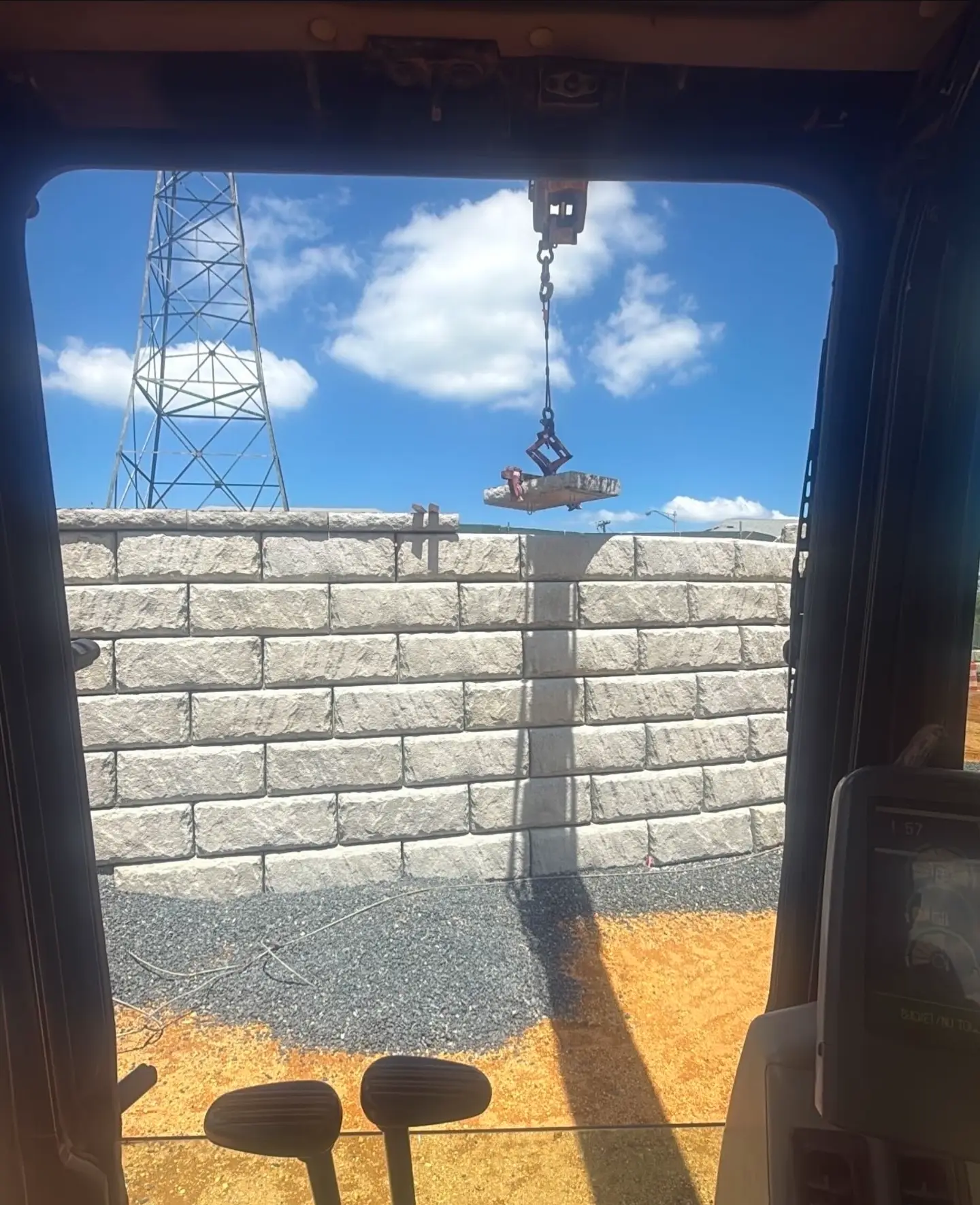 Retaining wall installation visible from a window