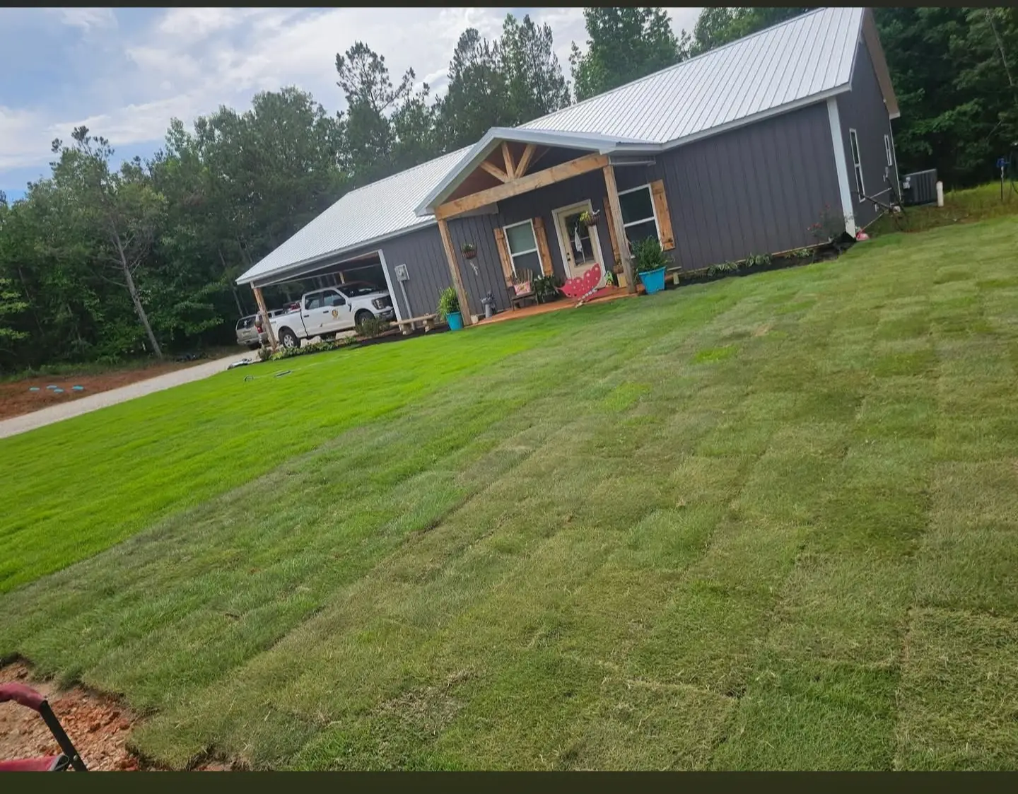 Fresh sod installation and yard renovation around a home