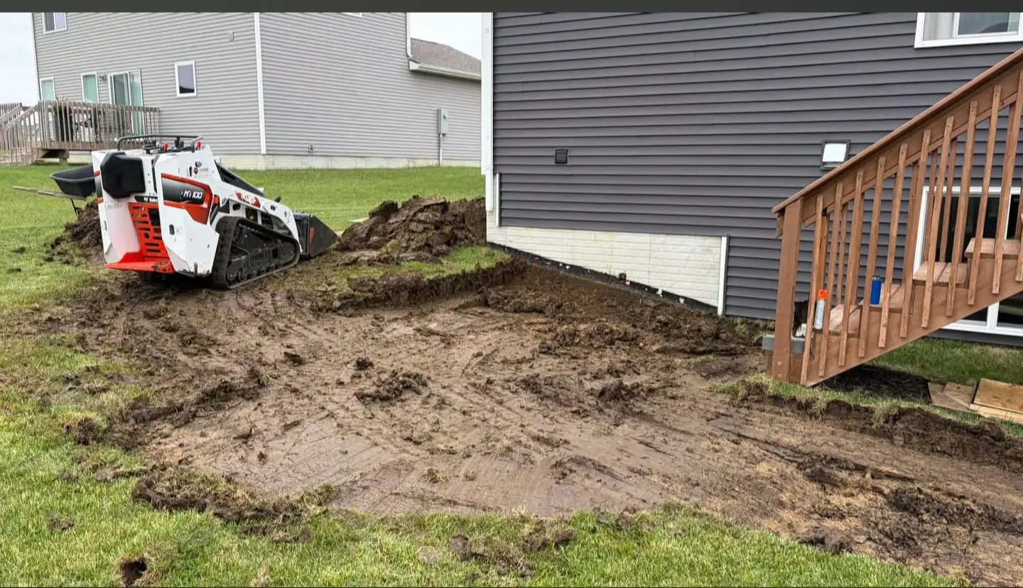 Yard grading and site preparation around a residential exterior